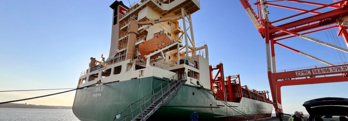 Cargo vessel “Lars D” during the handover in the port of Halifax (Canada) – vessel alongside the quay with a container crane.