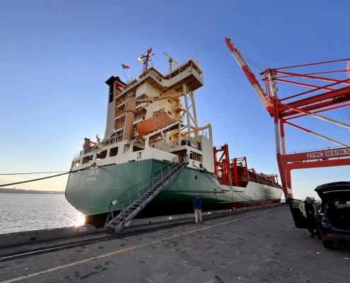 Cargo vessel “Lars D” during the handover in the port of Halifax (Canada) – vessel alongside the quay with a container crane.