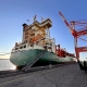 Cargo vessel “Lars D” during the handover in the port of Halifax (Canada) – vessel alongside the quay with a container crane.